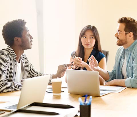 Colaboradores sentado a mesa mostrando o Engajamento de equipe