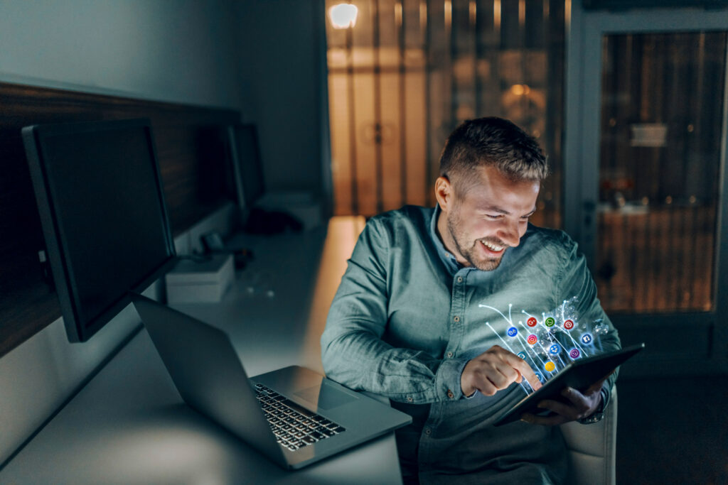 Homem sentado vendo a comunicação empresarial interna em um tablet